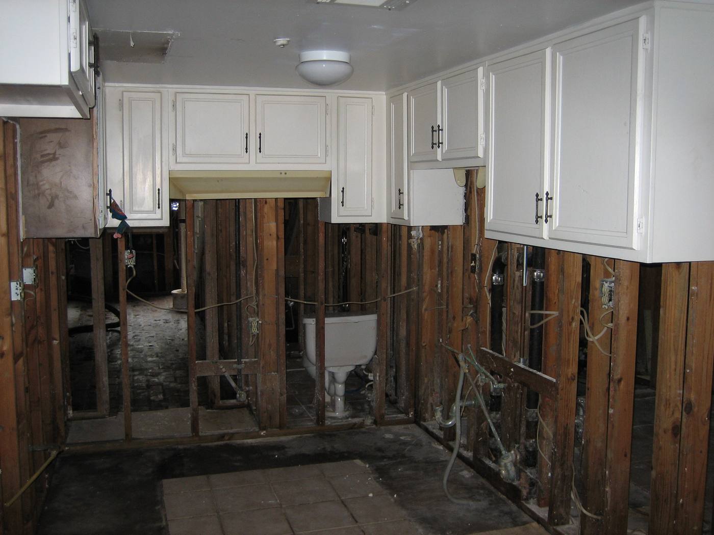 Standing water in a residential kitchen after a leak